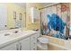 A well-lit bathroom with a sea turtle themed shower curtain at 315 60Th Ave. N, North Myrtle Beach, SC 29582
