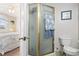 Bathroom with frosted glass shower, toilet, and view into bedroom at 315 60Th Ave. N, North Myrtle Beach, SC 29582