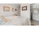Bedroom with nautical bedding, light-colored walls, and view into the bathroom at 315 60Th Ave. N, North Myrtle Beach, SC 29582