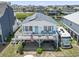 Inviting coastal home featuring a charming front deck, solar panels, and a well-kept lawn with ample parking at 315 60Th Ave. N, North Myrtle Beach, SC 29582