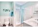 Stylish bathroom featuring beadboard accent, light blue walls, walk-in shower, and single vanity at 321 Rycola Circle, Surfside Beach, SC 29575