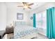 Bright bedroom featuring a bed, ceiling fan, and window with curtains at 321 Rycola Circle, Surfside Beach, SC 29575