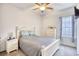 Cozy bedroom features carpeted floors, ceiling fan, window, and matching white furnishings at 321 Rycola Circle, Surfside Beach, SC 29575