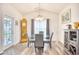 Bright dining room with a chandelier, gray chairs, and a grandfather clock next to the doorway at 321 Rycola Circle, Surfside Beach, SC 29575