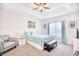 Relaxing main bedroom with a tray ceiling, a comfortable chair, and a large window with natural light at 321 Rycola Circle, Surfside Beach, SC 29575