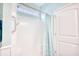 Bright shower with white surround, small window, grab bar, and decorative blue shower curtain at 321 Rycola Circle, Surfside Beach, SC 29575