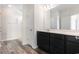 Bathroom features wood-look floors, a black vanity with a white countertop, and a large mirror at 3321 Little Bay Dr., Conway, SC 29526