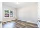 Bedroom with wood-look floors and a large window overlooking a residential street with a red car at 3321 Little Bay Dr., Conway, SC 29526