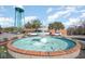 A three-tiered white fountain with blue water and surrounding walkway creates a welcoming community focal point at 3332 Little Bay Dr., Conway, SC 29526