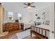 Bright bedroom featuring two twin beds, hardwood floors, and natural light streaming through shuttered windows at 342 Dogwood Dr. S, Murrells Inlet, SC 29576