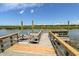 Private wooden dock offers picturesque waterfront views with lush green landscape at 342 Dogwood Dr. S, Murrells Inlet, SC 29576