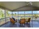 Cozy screened porch featuring ceiling fan and waterfront views; perfect for relaxing at 342 Dogwood Dr. S, Murrells Inlet, SC 29576