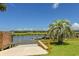 Scenic waterfront view with private dock and lush landscaping with palm trees at 342 Dogwood Dr. S, Murrells Inlet, SC 29576