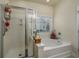 Bathroom featuring a tub and walk-in shower behind a glass door, offering a luxurious bathing experience at 3507 Club Course Dr., North Myrtle Beach, SC 29582