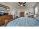 Bright bedroom with a ceiling fan, a large bed, wooden furniture, and an open doorway to an attached bathroom at 3507 Club Course Dr., North Myrtle Beach, SC 29582