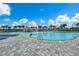 Large community pool with palm trees, clear blue water, pool-side lounge chairs, and a blue summer sky at 3507 Club Course Dr., North Myrtle Beach, SC 29582