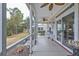 Relaxing screened porch with ceiling fans, seating, and views of the surrounding greenery at 3507 Club Course Dr., North Myrtle Beach, SC 29582