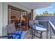 Balcony featuring a table and chairs with blue cushions and views of a building and palm trees at 400 20Th Ave. N # 101, Myrtle Beach, SC 29577