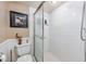 Bathroom featuring a shower with a sliding glass door, white tile, and coastal-themed decor at 400 20Th Ave. N # 101, Myrtle Beach, SC 29577