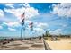 View of the Boardwalk with the American flag and palm trees on a clear, sunny day at 400 20Th Ave. N # 101, Myrtle Beach, SC 29577