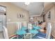 Cozy dining area with a glass-top table and white chairs, adjacent to the kitchen at 400 20Th Ave. N # 101, Myrtle Beach, SC 29577