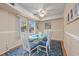 Bright dining area with a glass-top table, comfortable seating, and beach artwork at 400 20Th Ave. N # 101, Myrtle Beach, SC 29577