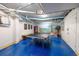 Basement game room with a ping pong table, mural, and blue epoxy floors at 400 20Th Ave. N # 101, Myrtle Beach, SC 29577