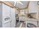 Well-lit kitchen with white cabinets, granite countertops, and modern appliances at 400 20Th Ave. N # 101, Myrtle Beach, SC 29577