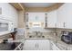 Compact kitchen with white cabinetry, granite countertops, and tiled backsplash at 400 20Th Ave. N # 101, Myrtle Beach, SC 29577