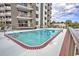 Community pool with a view of a building, landscaping, and outdoor furniture at 400 20Th Ave. N # 101, Myrtle Beach, SC 29577