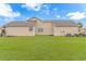 Rear exterior of home showing a large, grassy lawn and well-kept landscaping at 401 Oak Crest Circle, Longs, SC 29568