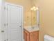 Bathroom with a single sink vanity, mirror, and ample lighting at 401 Oak Crest Circle, Longs, SC 29568