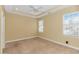 Bedroom with neutral walls, carpet, and abundant natural light from large windows at 401 Oak Crest Circle, Longs, SC 29568