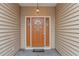 Inviting front entrance showcasing a stylish door with sidelights and elegant exterior lighting at 401 Oak Crest Circle, Longs, SC 29568