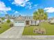 Attractive home with a manicured lawn, palm trees, and a two-car garage at 401 Oak Crest Circle, Longs, SC 29568