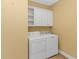 Well-equipped laundry room with cabinets and a white washer and dryer at 401 Oak Crest Circle, Longs, SC 29568