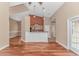 Open-concept living space featuring hardwood floors, a neutral color palette, and kitchen access at 401 Oak Crest Circle, Longs, SC 29568