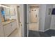 Bright bathroom featuring a granite countertop, and a doorway to the main hallway at 410 Melrose Pl. # 304, Myrtle Beach, SC 29572