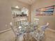 Cozy dining area with a glass-top table, seating for four, and a view of the kitchen at 410 Melrose Pl. # 304, Myrtle Beach, SC 29572