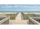 Picturesque beach access with a wooden walkway leading to the ocean and sandy beach at 415 28Th Ave. N # 4-A, Myrtle Beach, SC 29577