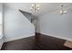 Open living room with dark hardwood floors, chandelier, and view of the staircase, fireplace and doorway at 425 Retriever Ct., Murrells Inlet, SC 29576