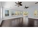 Large living room with multiple windows, ceiling fans and hardwood flooring at 425 Retriever Ct., Murrells Inlet, SC 29576