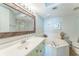 Bright bathroom with a soaking tub, a decorative mirror and a modern sink at 4301 S Ocean Blvd. # 7A, North Myrtle Beach, SC 29582