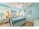 Bedroom with nautical decor, ceiling fan, and light turquoise walls at 4301 S Ocean Blvd. # 7A, North Myrtle Beach, SC 29582