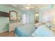 Bedroom featuring a light turquoise color scheme, nautical decor, ceiling fan, and wood-look floors at 4301 S Ocean Blvd. # 7A, North Myrtle Beach, SC 29582