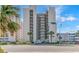 Exterior shot of condo building with palm trees and covered parking at 4301 S Ocean Blvd. # 7A, North Myrtle Beach, SC 29582