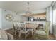 Dining room with a chandelier and dining table and an open view into the kitchen at 4301 S Ocean Blvd. # 7A, North Myrtle Beach, SC 29582