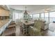 Dining room with wicker chairs and open view to living area with ocean views at 4301 S Ocean Blvd. # 7A, North Myrtle Beach, SC 29582