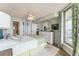 Main bedroom with ceiling fan, ocean view, and ensuite bathroom at 4301 S Ocean Blvd. # 7A, North Myrtle Beach, SC 29582