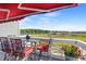 Charming balcony with red awning and seating overlooks marsh and water views at 4396 Baldwin Ave. # 19, Little River, SC 29566